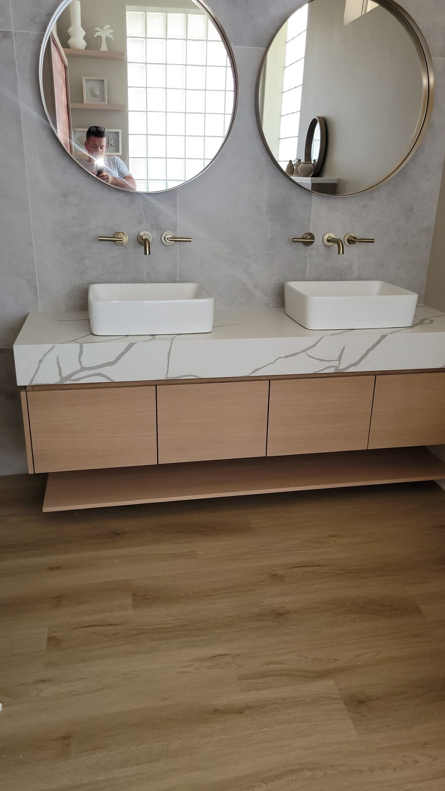 Modern double vanity in light wood with twin vessel sinks